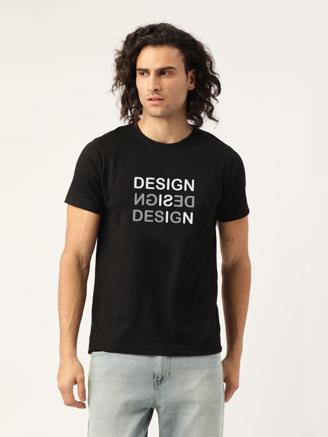 A close-up of a HinglishWear t-shirt with the text "design is design" printed on it. Title