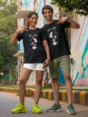 A South Asian couple wearing Hinglish t-shirts. The girl's shirt reads "He's Mine" and the boy's shirt reads "She's Mine."